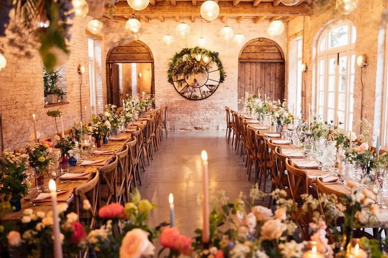 A long table set for an event in a converted barn